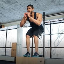 man doing box jumps