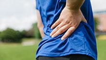 person with hand on back