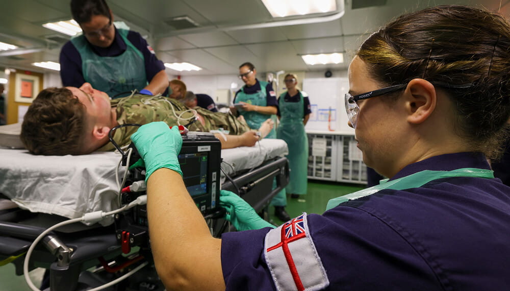 Royal Navy healthcare and medical team caring to a patient