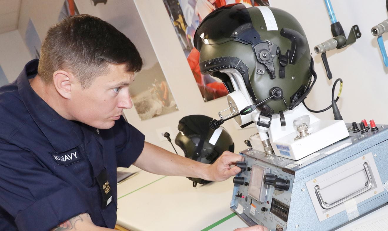 Survival Equipment Technician performing helmet testing