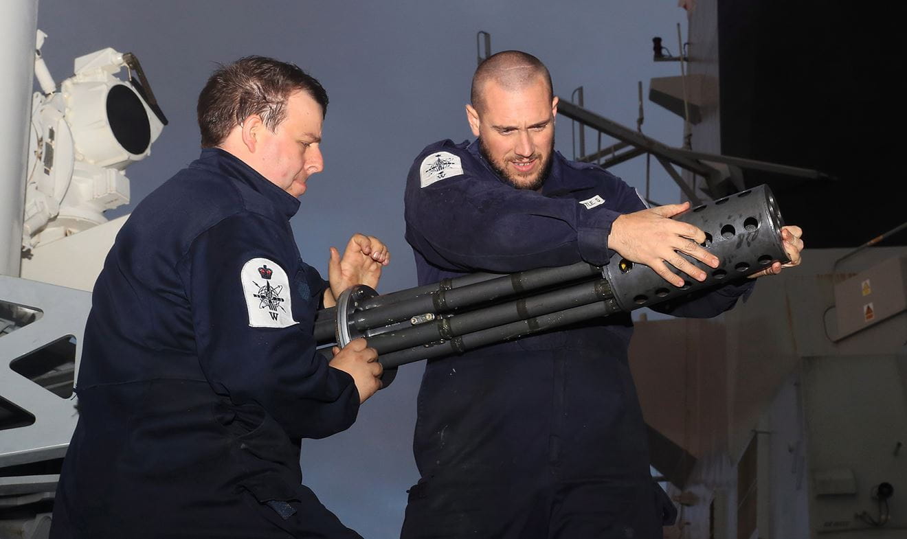 Petty Officer Engineering Technician (Weapons Engineering) and Leading Engineering Technician (Weapons Engineering) working on the Phallanx
