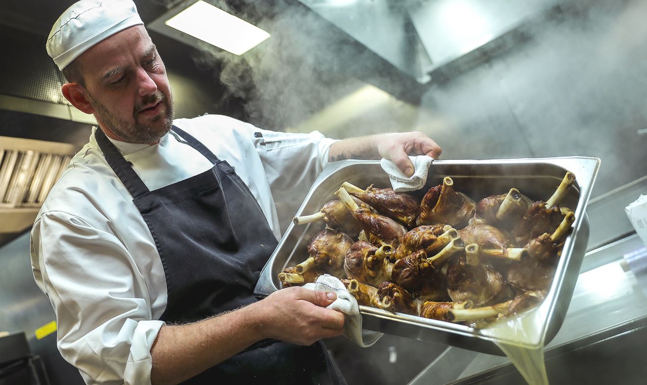 Chef at work in the Galley of HMS Diamond preparing food for the Ship's Company' evening meal time