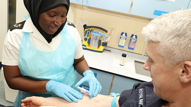 medical assistant taking blood from patient