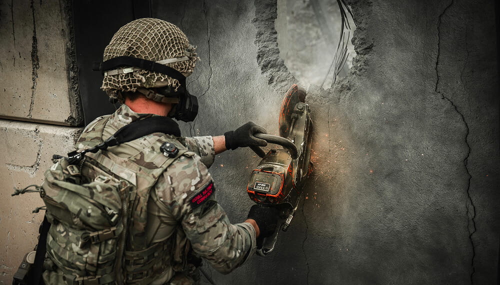 Royal Marine cutting through a concrete wall