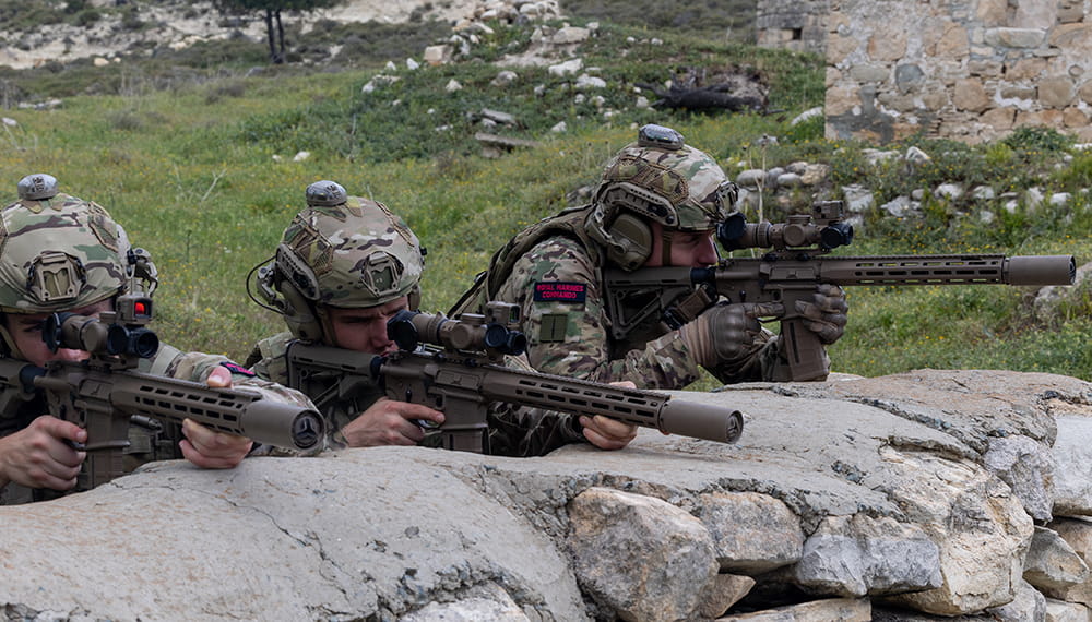 royal-navy-careers-royal-marines-reserves-05 Royal Marines in a line wearing equipment and holding weapons. Photograph of day one of the new advert shoot in Cyprus.