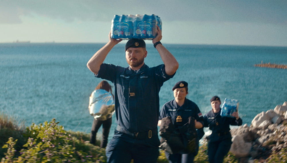 royal-navy-careers-surface-fleet-02 The image shows three navy personnel carrying supplies near the sea. The surface fleet defends the UK’s interests, keeps global trade flowing and provides support to civilians affected by natural disaster.