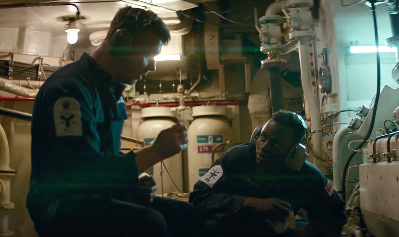 Royal Navy personnel discuss a task