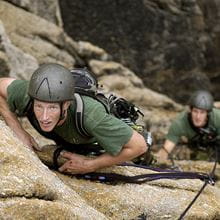 Climbers on a steep wall looking up