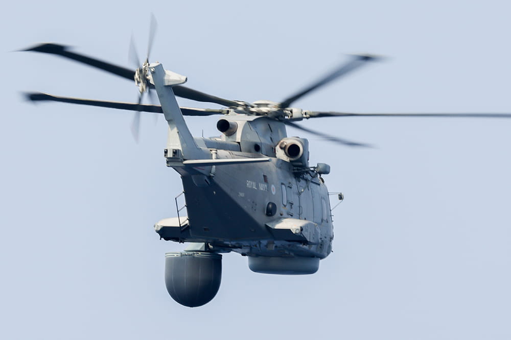 Royal Navy Merlin helicopter flying away from the camera