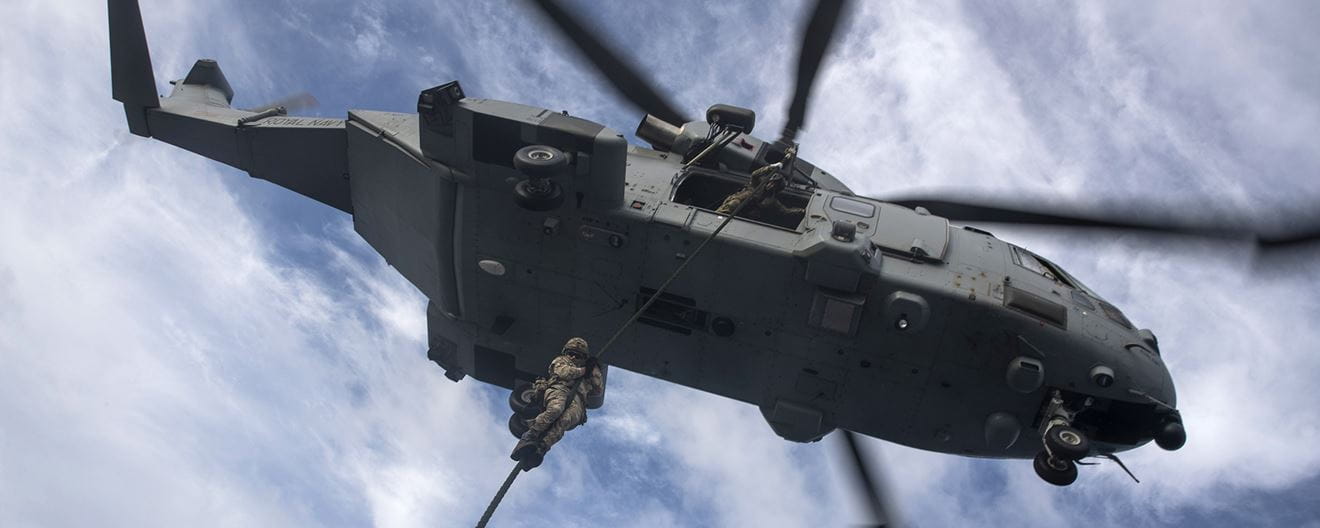 Royal-Navy-Equipment-Commando-By-Air-04-Fast-Roping-Into-Combat Marine performing fast rope training from a Merlin