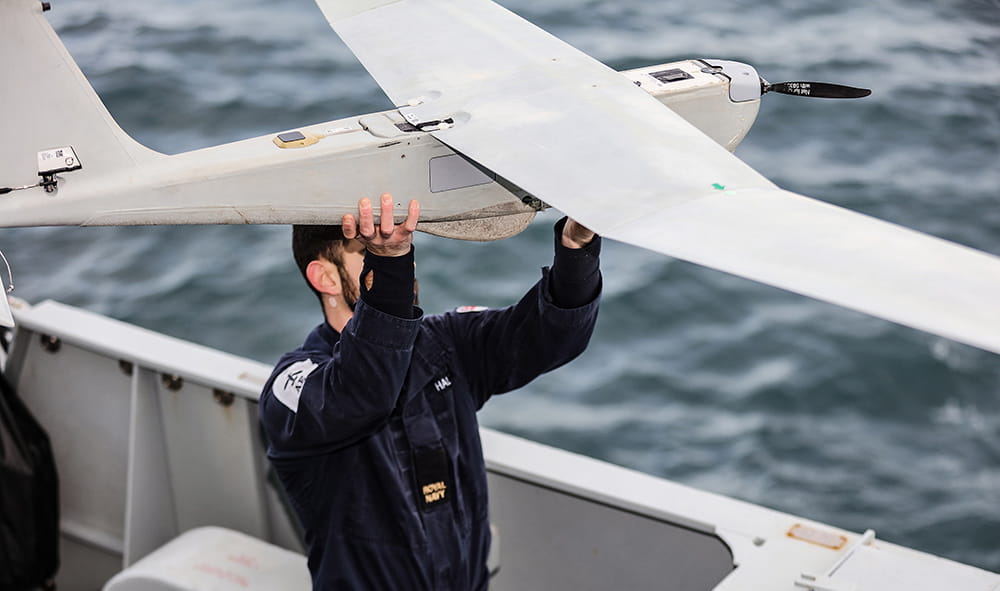 Royal-Navy-Equipment-Commando-By-Air-05-Puma-3-AE Surface Fleet personnel holding a Puma drone ready for launch