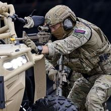 Royal-Navy-Equipment-Commando-Weaponry-09-Colt-Canada-C8-Carbine Commando aiming a Colt Canada C8 Carbine from behind a vehicle