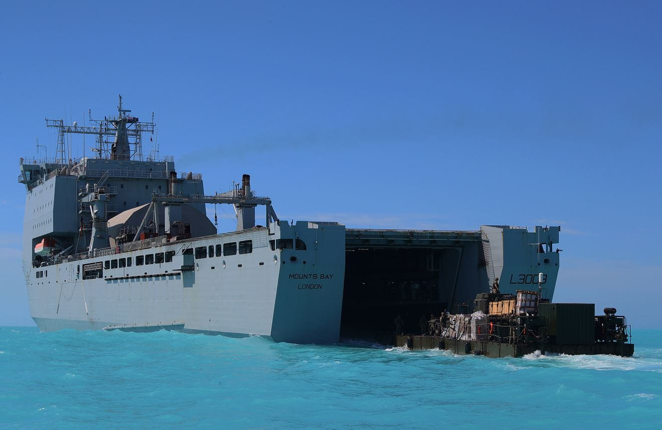 Rigid-hulled inflatable boat being deployed from the hull of the RFA Mounts Bay