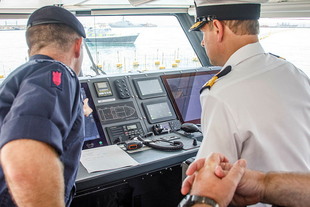 HRH Prince Edward being talked through the instruments onboard the HMS Cutlass bridge