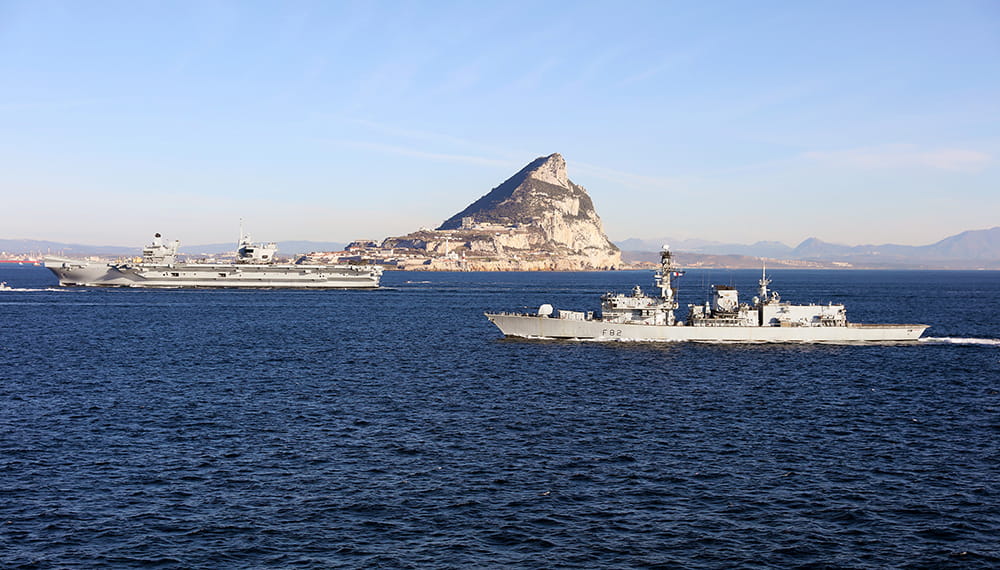Royal-Navy-Global-Operations-06-Mediterranean-and-Black-Sea HMS Queen Elizabeth Aircraft Carrier and frigate in front of rock of Gibraltar