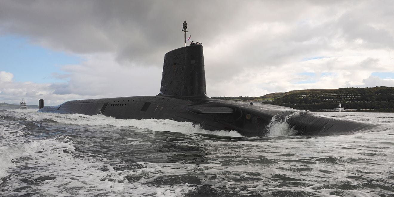 Royal-Navy-Global-Operations-08-Continuous-at-Sea-Deterrent HMS Victorious leaving HMNB Clyde, top half of sub visible above the water