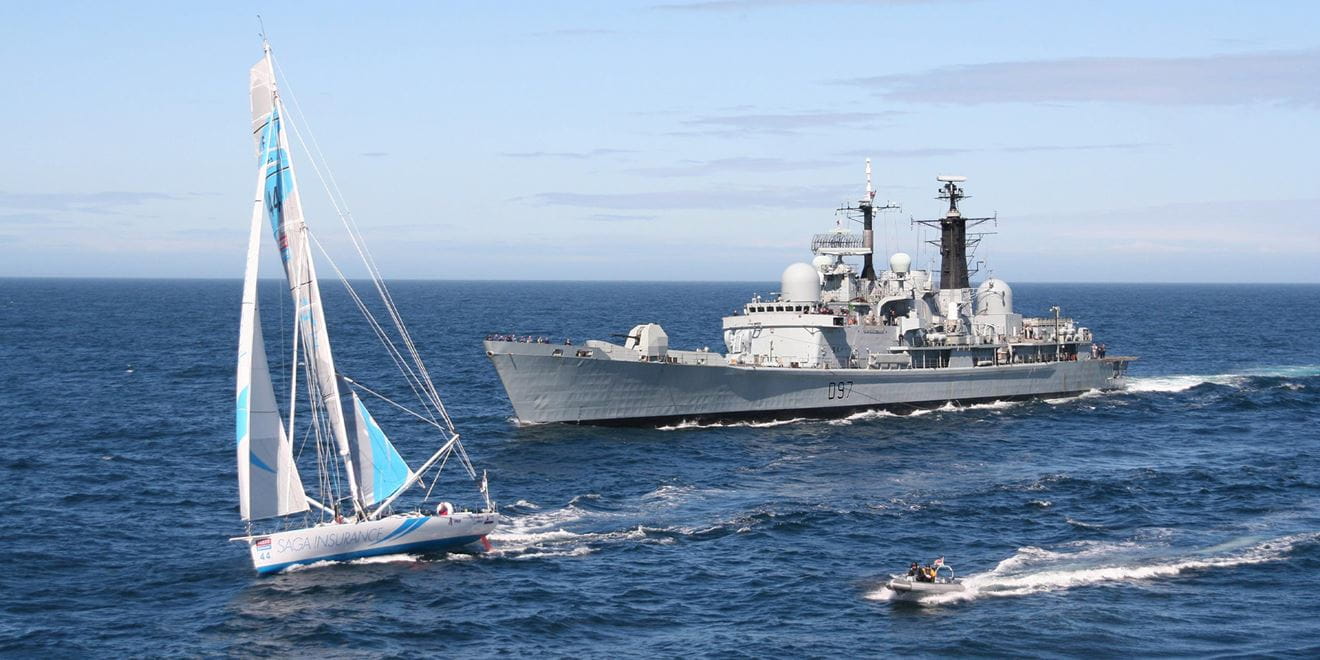 A Duke class frigate, a sailing boat and a small patrol boat sail past the camera.