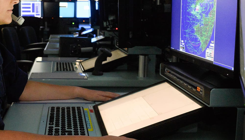 Navy Sailor using the navigational system aboard the ship