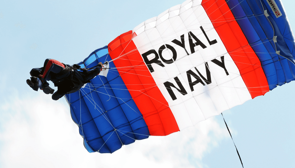 Royal navy display team parachuter in the air with canopy above