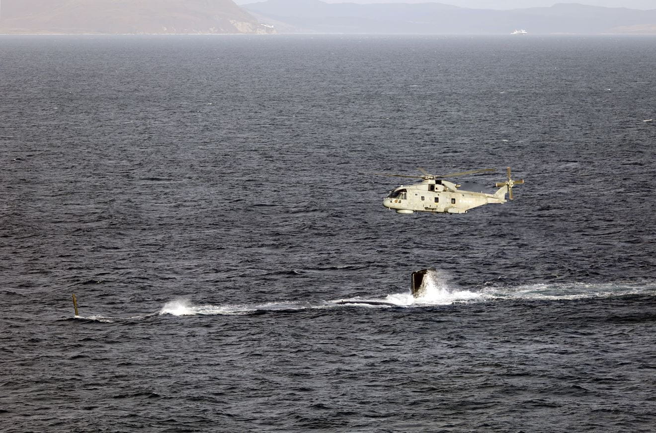 A Merlin Mk2 passes over HMS Agamemnon as the new Astute-class submarine conducts her maiden dive at sea A Merlin Mk2 passes over HMS Agamemnon as the new Astute-class submarine conducts her maiden dive at sea