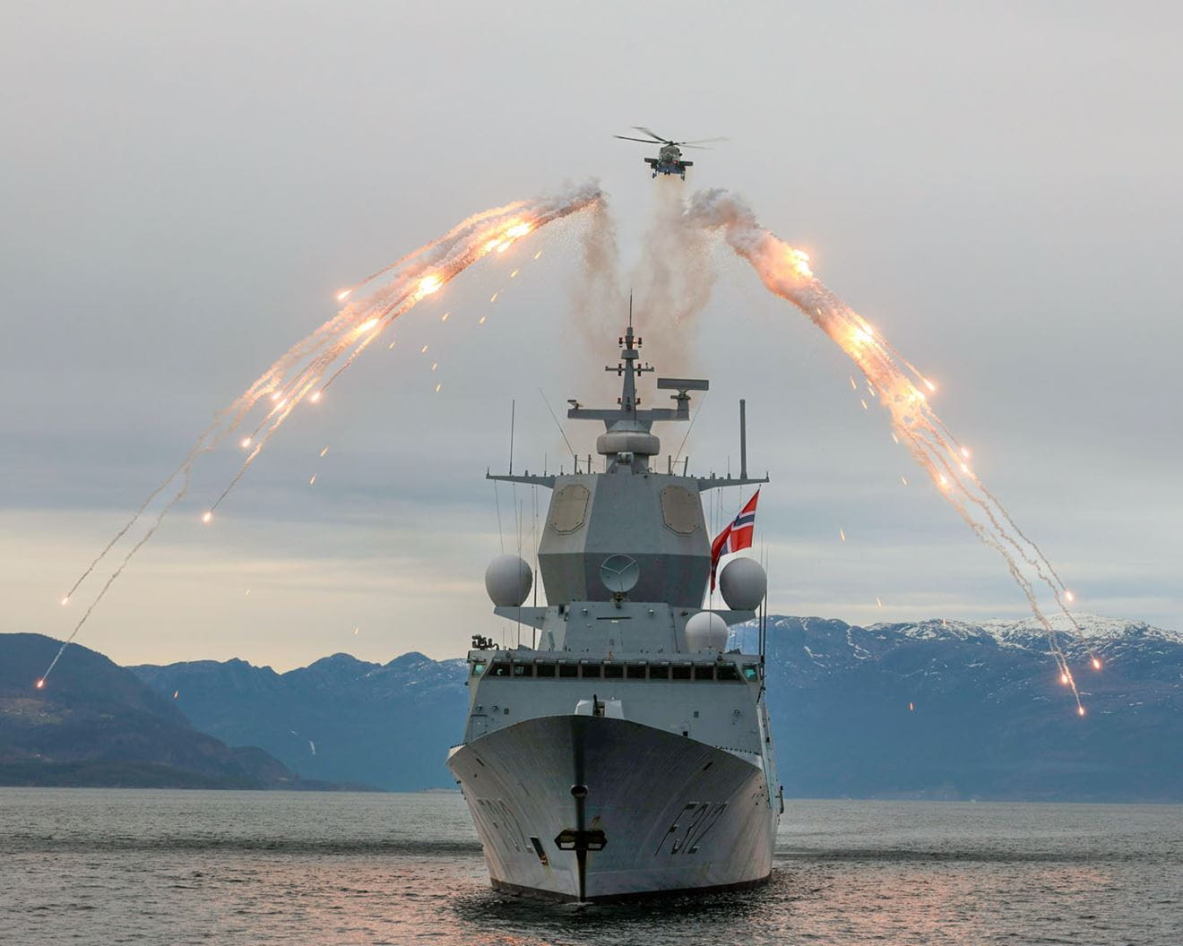 A Wildcat pumps out flares in an impressive display over HNoMS Sverdrup