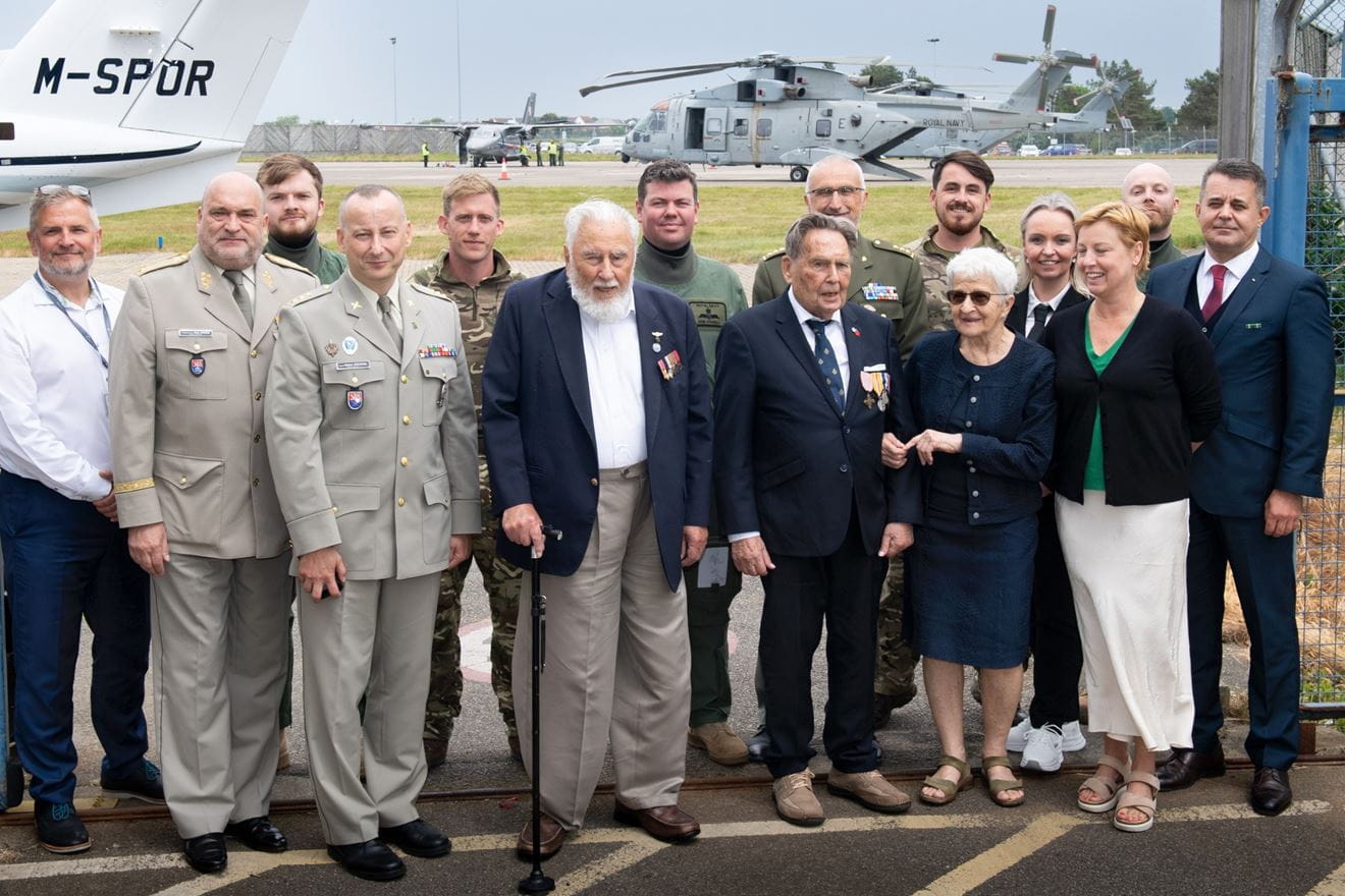 Some of the aircrew pose with the Czech veterans in front of the 845 NAS Merlins in Jersey Some of the aircrew pose with the Czech veterans in front of the 845 NAS Merlins in Jersey