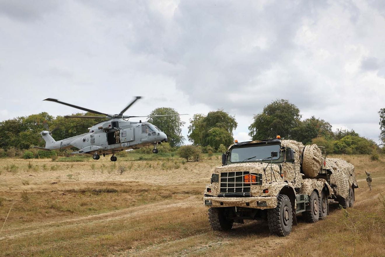 A Merlin helicopter comes into land at the refuelling site