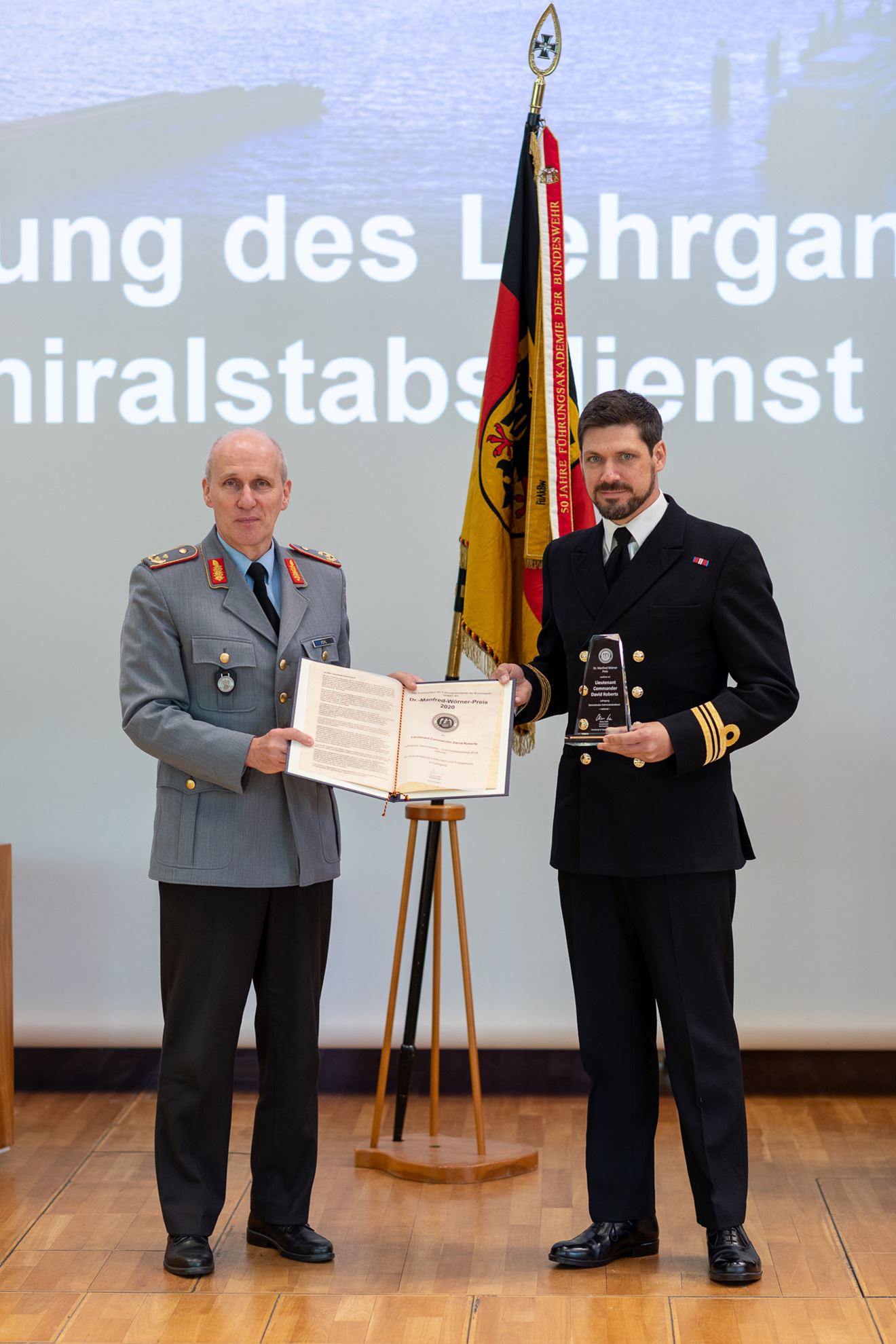 Lieutenant Commander David Roberts (pictured right) receives the top international student award from the commander of the German Armed Forces Staff College, Generalmajor Oliver Kohl
