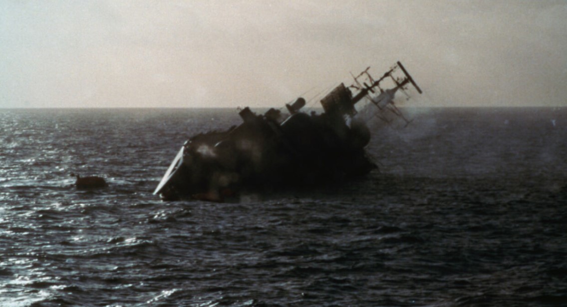 HMS Coventry heels to port after being hit by three bombs HMS Coventry heels to port after being hit by three bombs