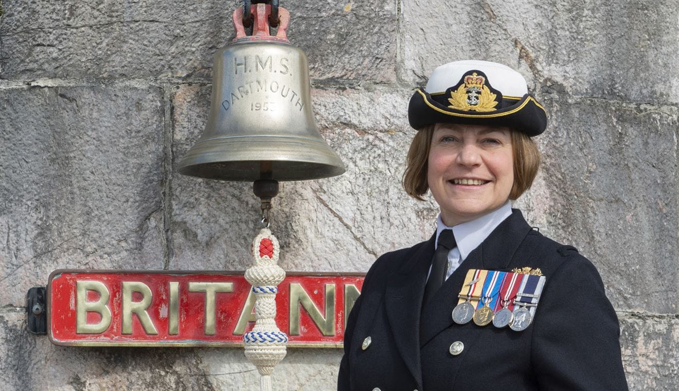 BRNCs new CO Captain Sarah Oakley in front of the colleges famous bell BRNCs new CO Captain Sarah Oakley in front of the colleges famous bell