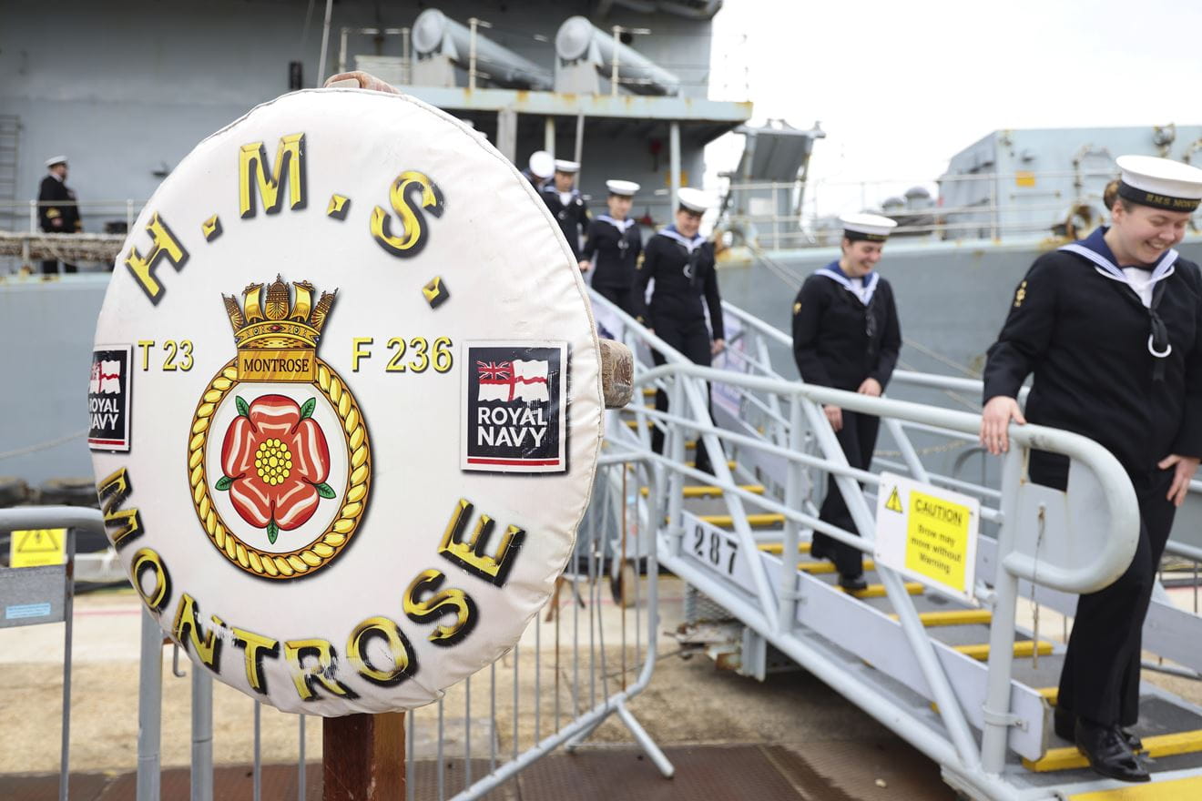 Personnel leave HMS Montrose for the final time at her decommissioning ceremony