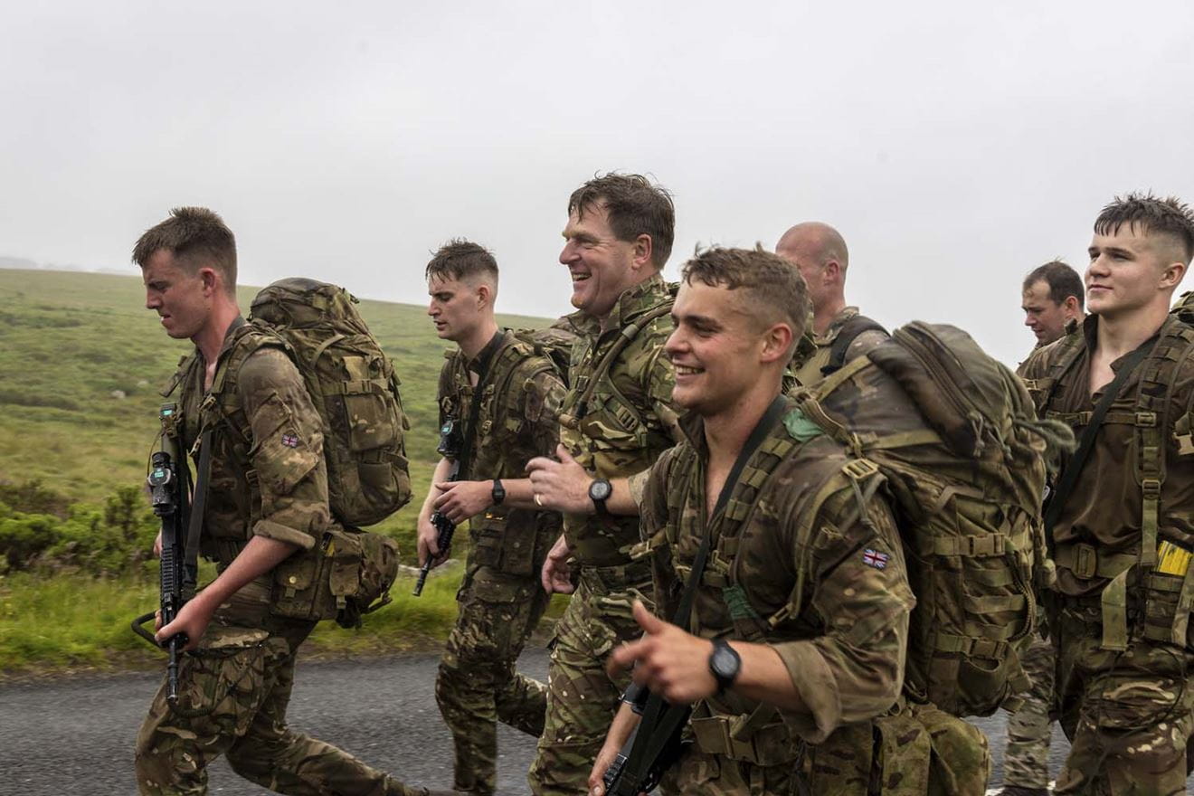 New marines receive Green Berets from First Sea Lord after he joined them on commando test