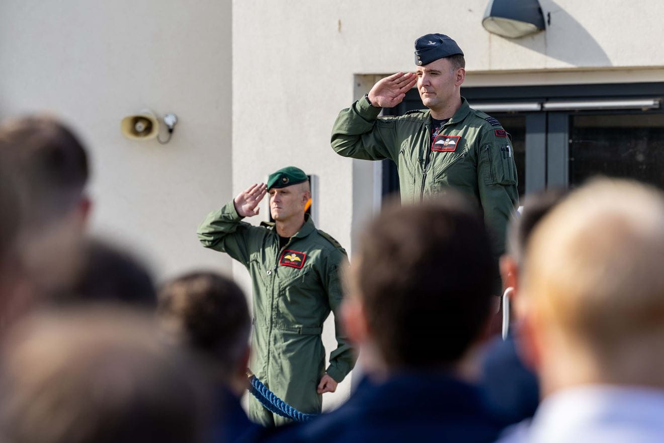 Wg Cdr Stew Cambpell salutes as he hands over command to Lt Col Mike Carty RM