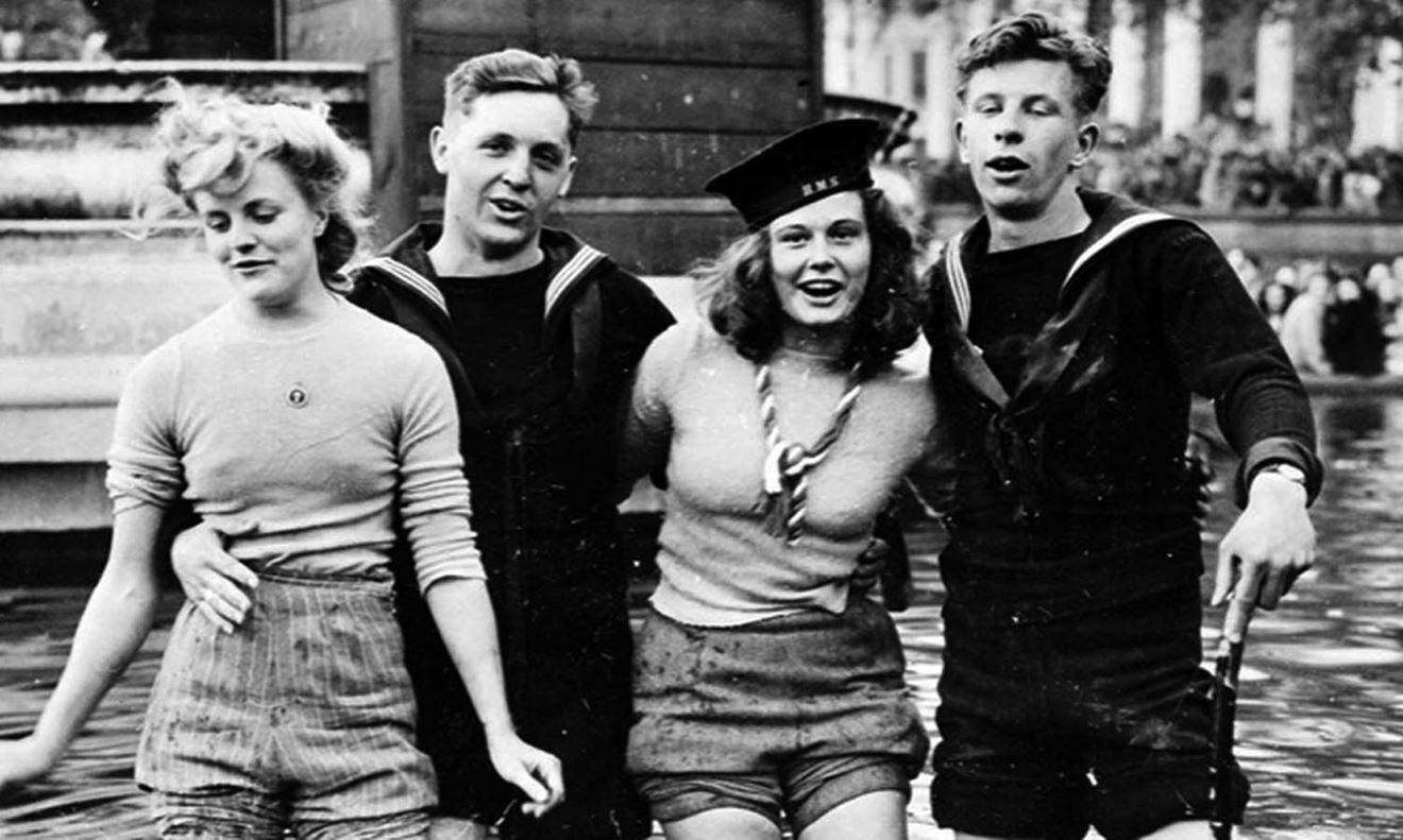 Joyce Digney left and Cynthia Covello celebrate VE Day 1945 with sailors in one of Trafalgar Squares