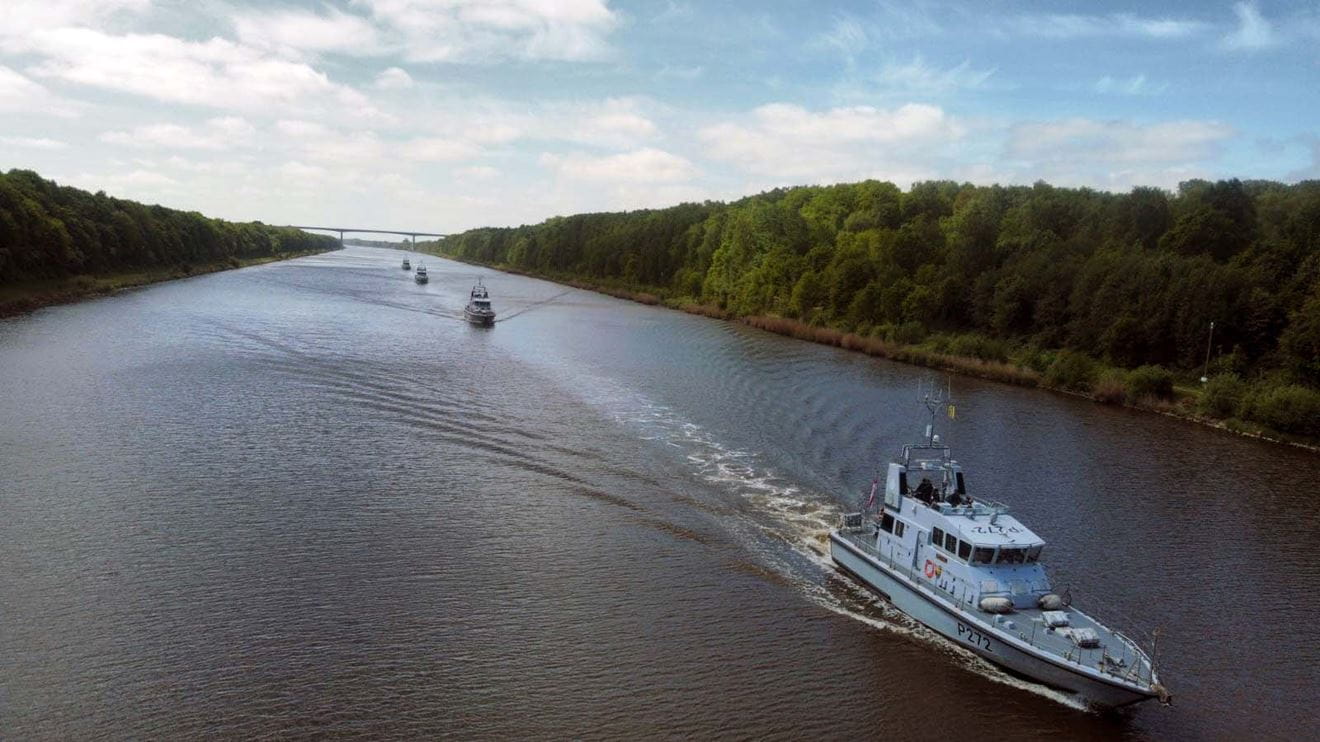 HMS Smiter leads three P2000s through the Kiel Canal