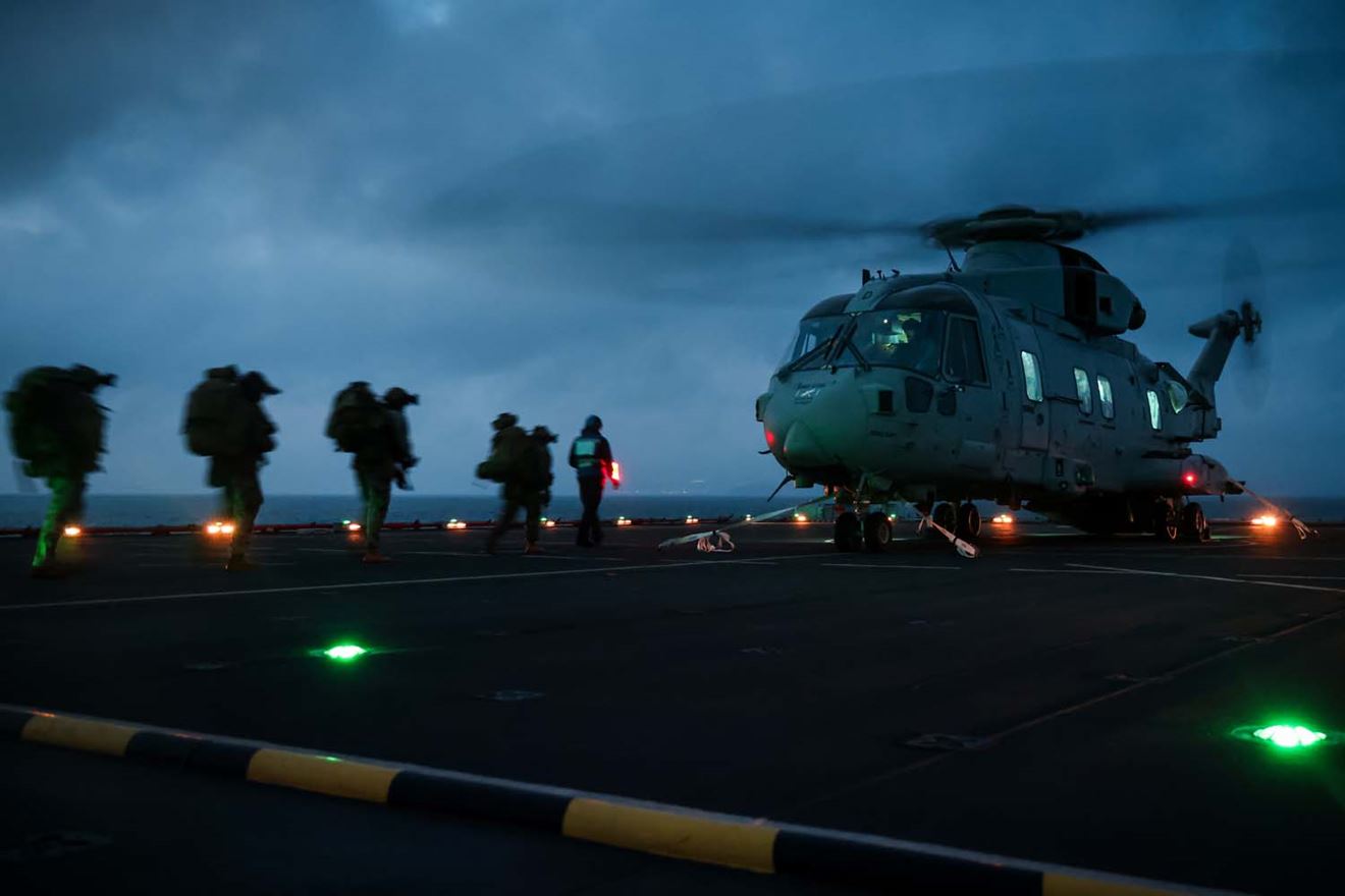Royal Marines load onto a Merlin on Lyme Bay's flight deck