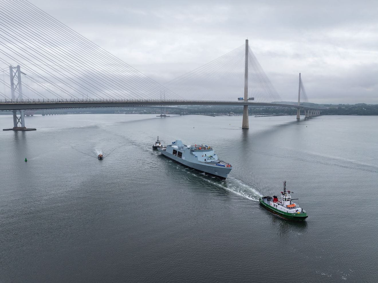 Tugs haul HMS Venturer past the two Forth road crossings