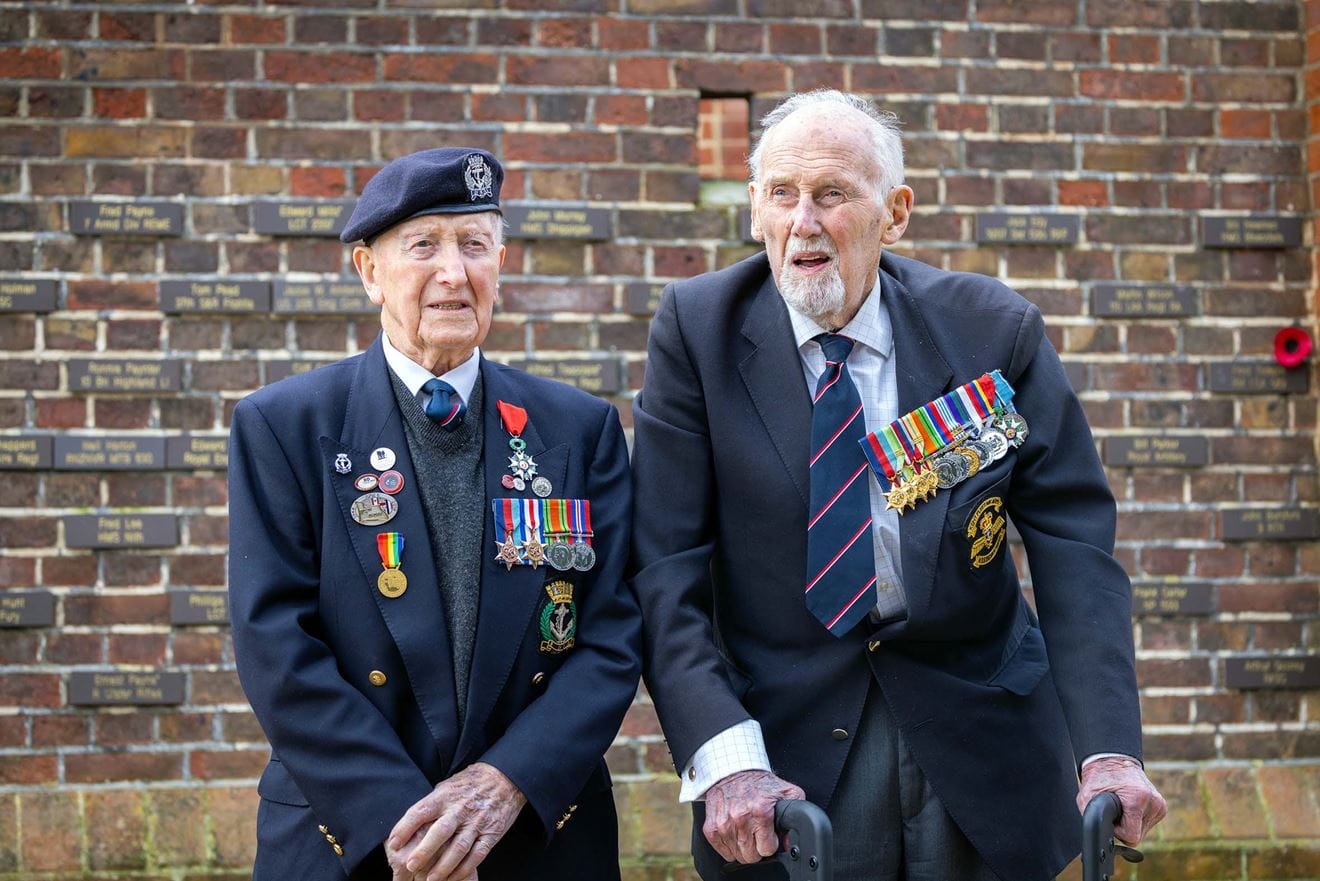 DDay veterans Stan Ford left and John Roberts in front of the memorial wall at the DDay Museum