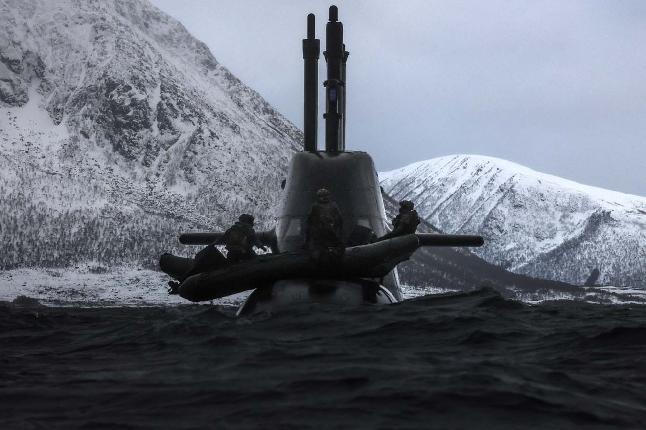 Royal Marines use inflatable raiding craft to conduct submarine raid
