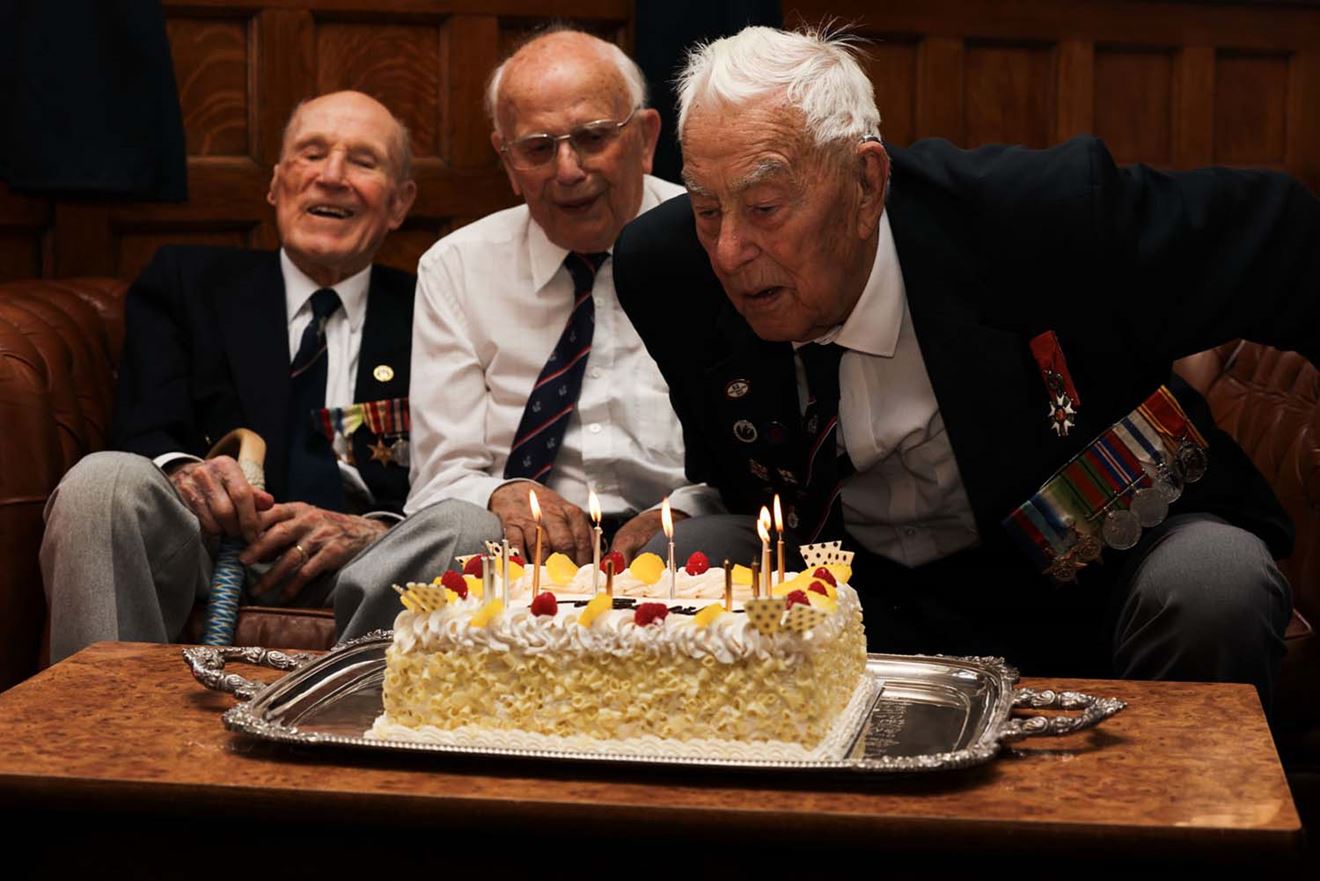 Len Chivers, Ken Arkell and Henry Rice blow out the candles on the cake