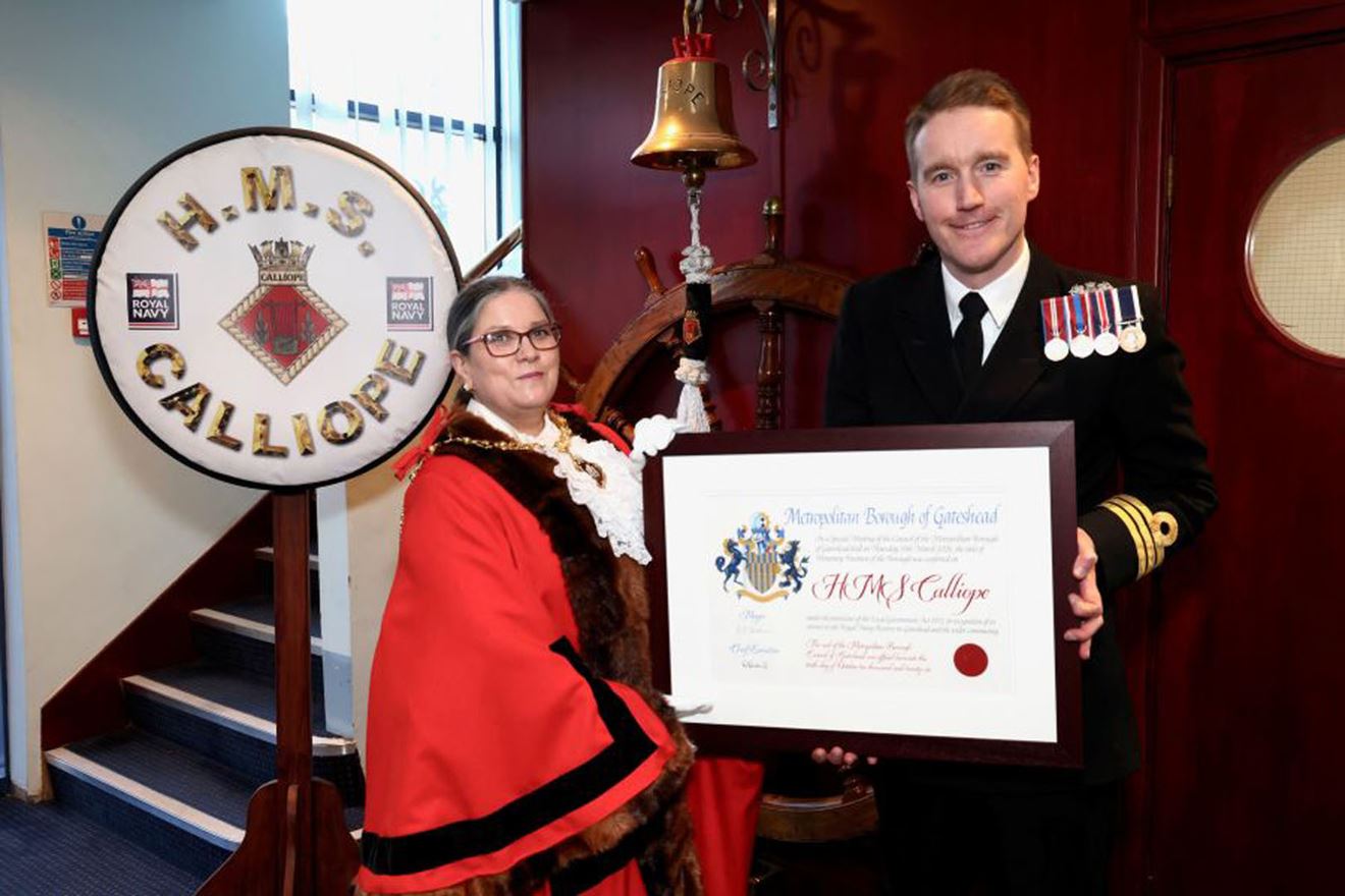 Commander King receives the Freedom Scroll on behalf of his unit Commander King (right) poses with the certificate.