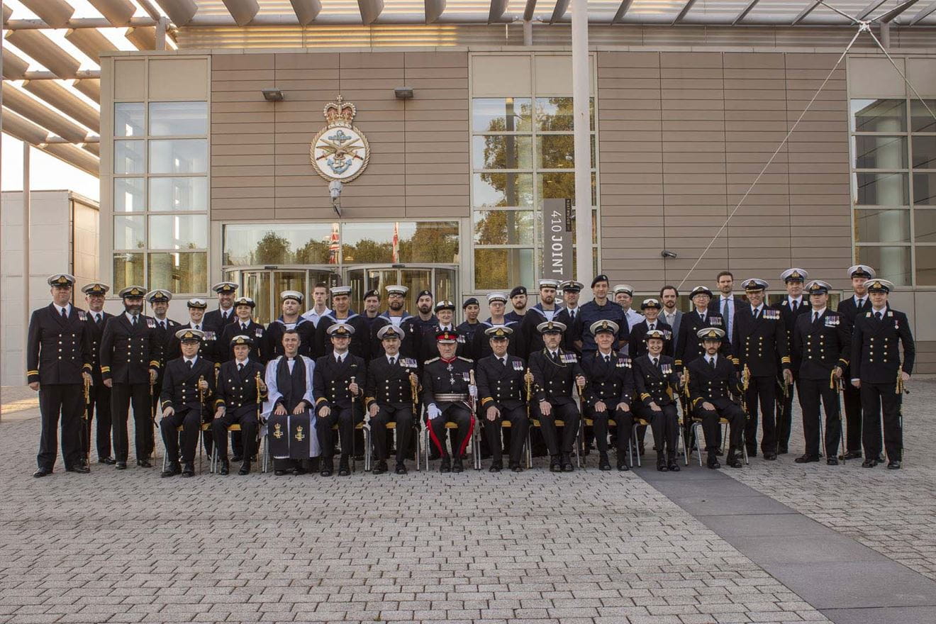 Wildfire personnel pose for an anniversary group shot