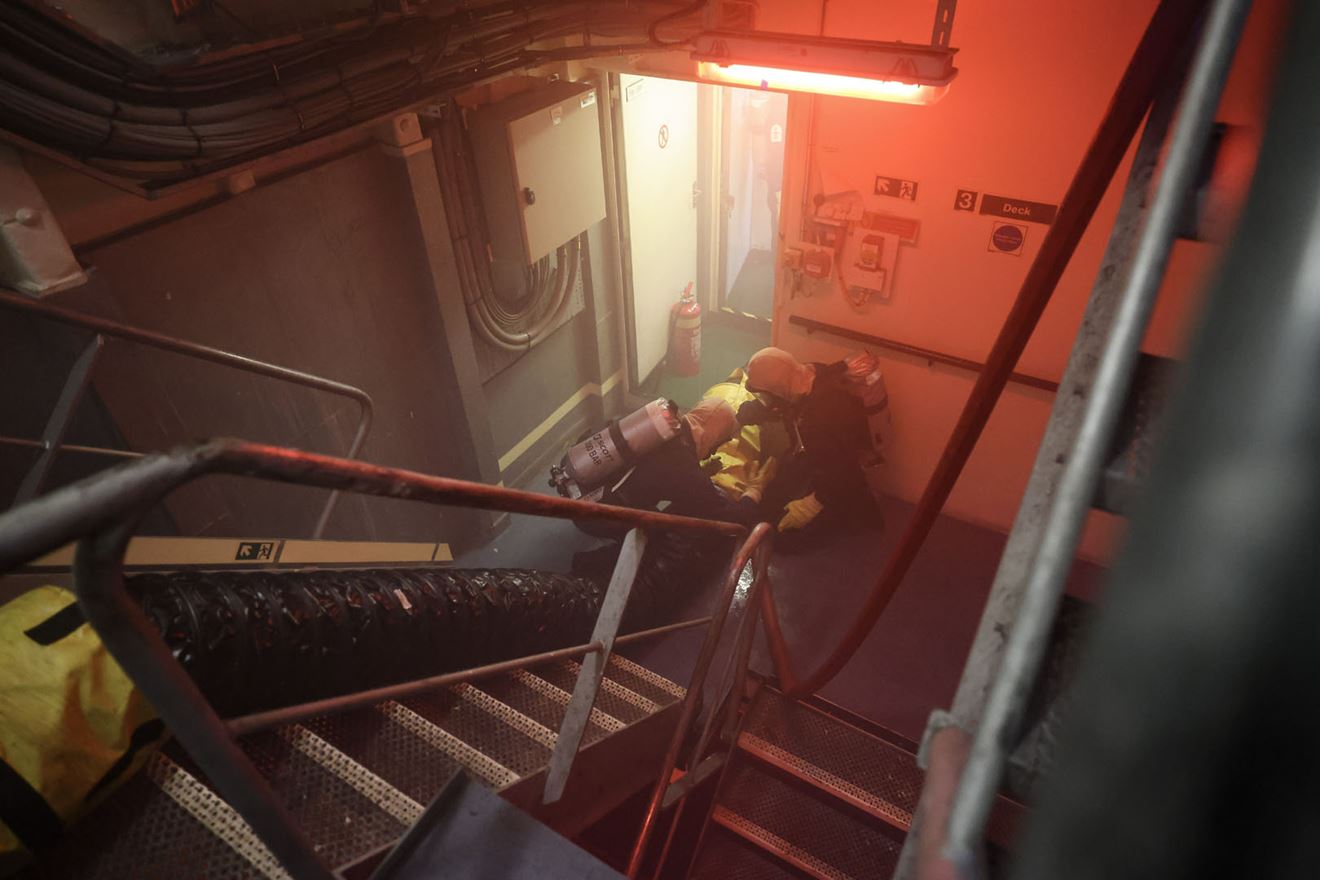 The firefighting party moves down one of the ships stairwells The firefighting party moves down one of the ships stairwells