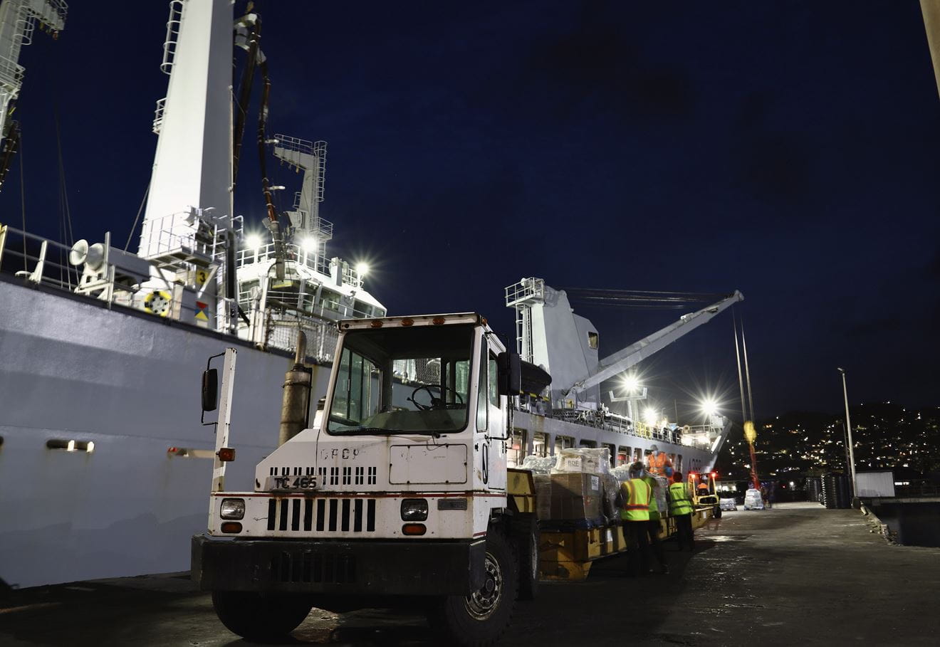 A low loader is loaded with aid from Barbados delivered by RFA Wave Knight