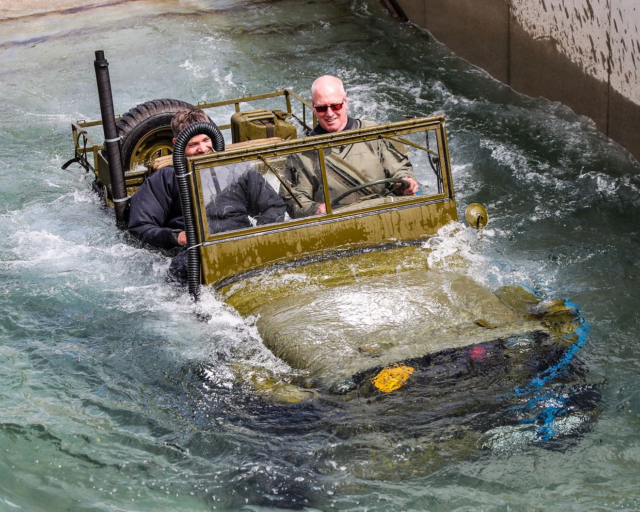 World War Two Willys jeep is driven through the dip tank at RM Instow. Picture: Paul Hall