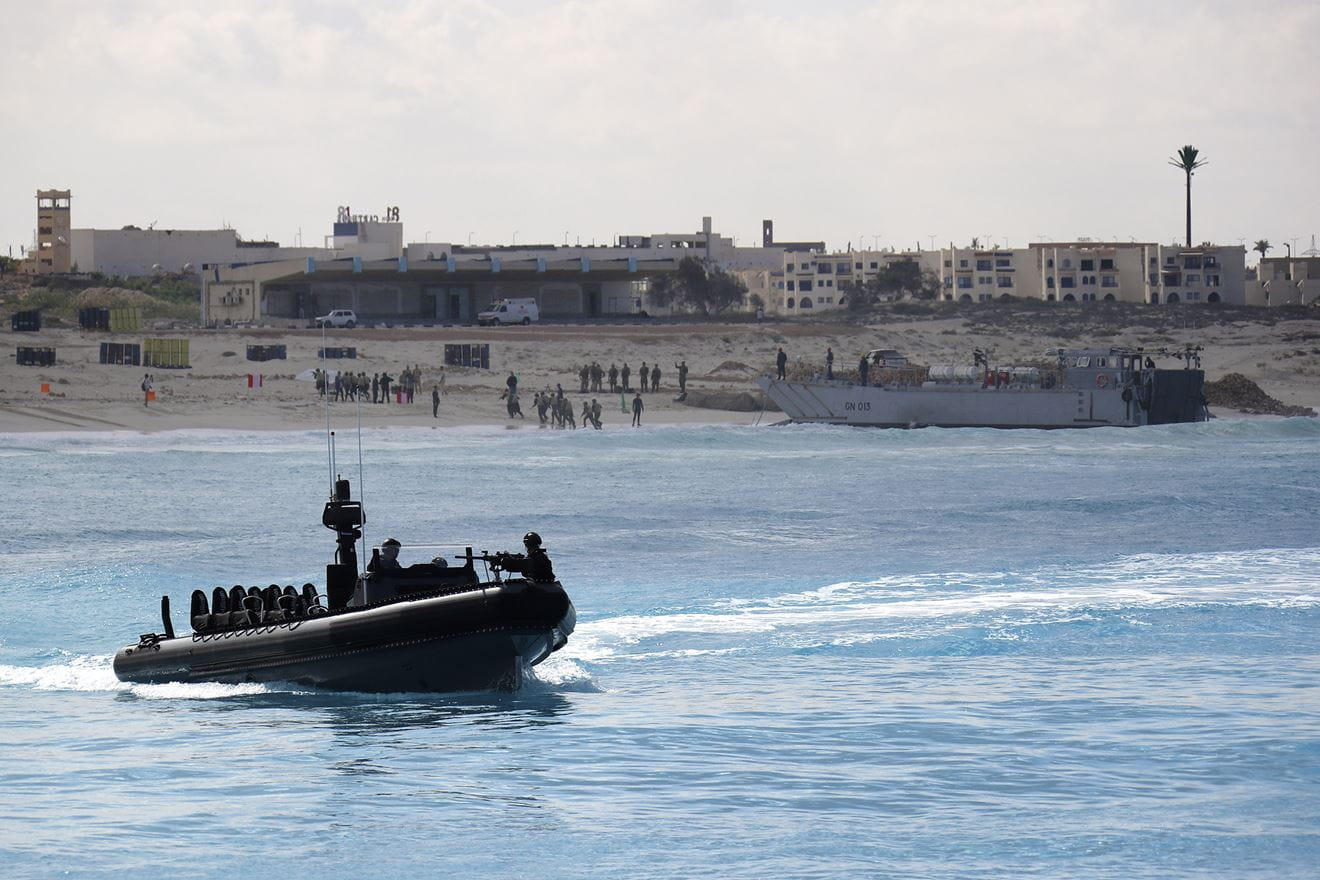 Egyptian troops come ashore by landing craft as a Royal Marines ORC patrols offshore Egyptian troops come ashore by landing craft as a Royal Marines ORC patrols offshore