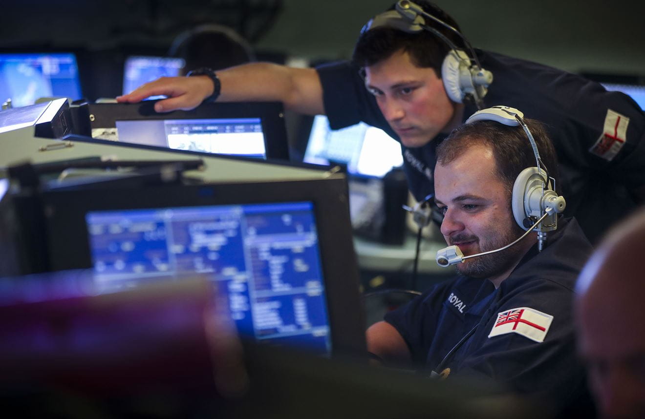 Sailors in HMS Dragon's operations room discuss a missile attack Sailors in HMS Dragon's operations room discuss a missile attack
