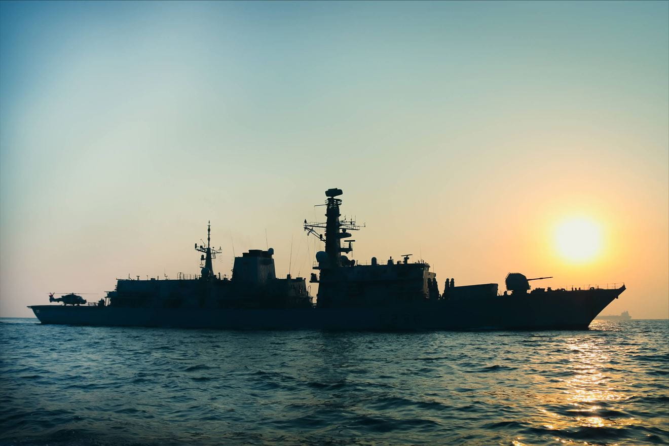 HMS Montrose on patrol at sunset with a tanker in the distance HMS Montrose on patrol at sunset with a tanker in the distance