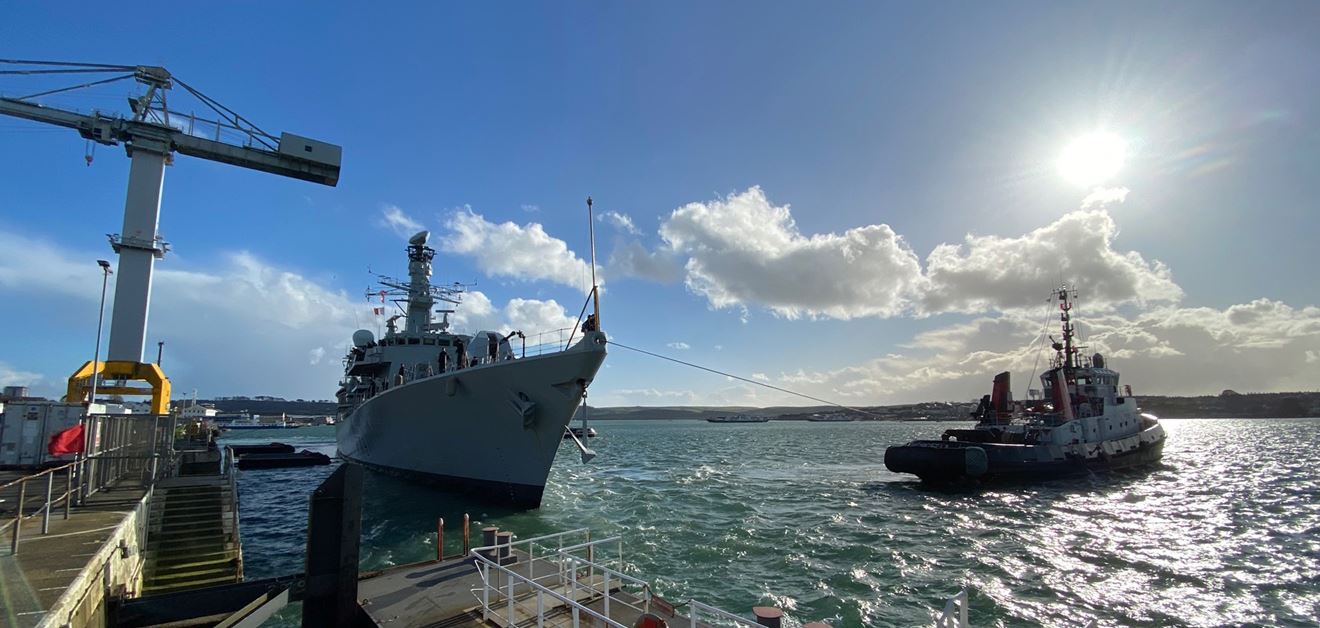 A tug helps HMS Portland away from the jetty A tug helps HMS Portland away from the jetty
