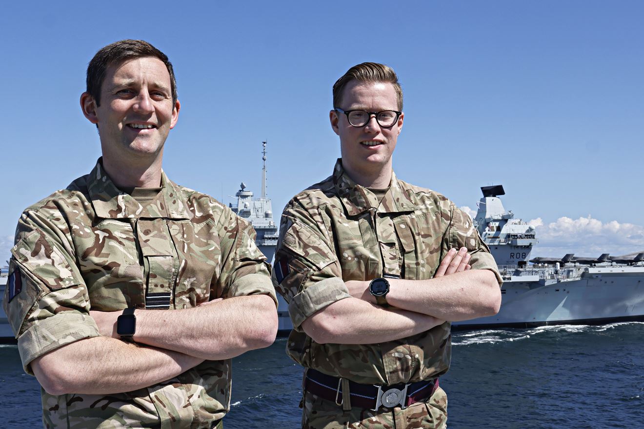 Flt Lts Chris Smith and Hayden Rose on HMS Prince of Wales with HMS QE in background Flt Lts Chris Smith and Hayden Rose on HMS Prince of Wales with HMS QE in background